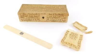 A Cantonese late 19thC ivory box, of rectangular section, carved in bas-relief with figures in a garden, 23.5cm wide, together with a Cantonese Ivory calling card case, decorated with figures within a border of flowers, 7.5cm high (AF), and an ivory lette
