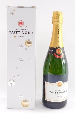 A bottle of Taittinger champagne, boxed.