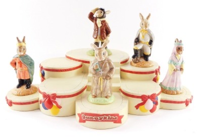 A Royal Doulton Bunnykins The Occasions Collections base, and five figures, comprising Airman Bunnykins, the Robin Hood Collection Prince John Bunnykins, Sheriff of Nottingham Bunnykins, Friar Tuck Bunnykins, and Maid Marian Bunnykins. (6)