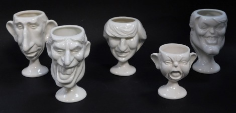 Five Fluck and Law Carlton ware pottery egg cups, modelled as members of The Royal Family, comprising His Royal Highness Prince Charles and Princess Diana, His Royal Highness Prince Andrew and Sarah Ferguson and a baby.