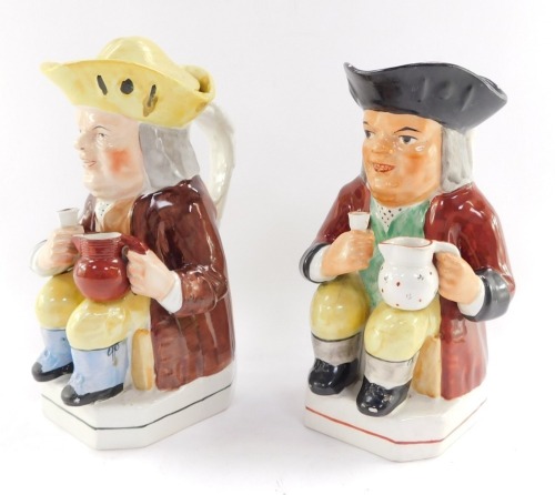 A Staffordshire 19thC pottery toby jug, modelled seated holding an ale glass and jug, tricorn hat with lid, 37cm high, and a further toby jug similarly modelled, 25cm high. (2, AF)