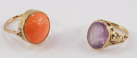 A coral ring, set in yellow metal, size N, together with an amethyst glass set ring in yellow metal, size N/O, 10.8g.