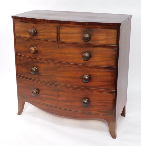 A late Georgian mahogany bowfront chest, with a plum pudding mahogany top, two short over three long graduated drawers, raised on outswept feet, 106cm high, 106cm wide, 52.5cm deep.