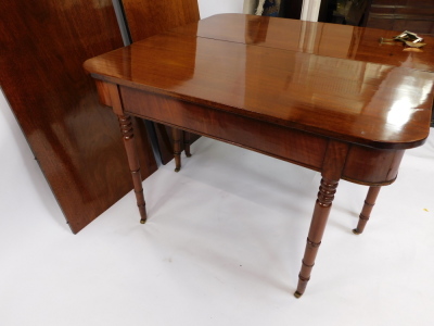 A George IV mahogany D end dining table, with two additional leaves, raised on turned legs, brass capped on castors, 77cm high, 118.5cm wide, 235cm extended, 56.6cm deep. - 3