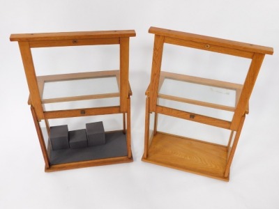 A pair of oak cabinets, for chemist scales, by Philip Harris Limited, Birmingham, with glazed sides and lift up front, raised on rubber feet, 3cm high, 46cm wide, 25.5cm deep. - 2