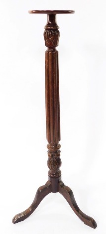 A Victorian mahogany jardiniere stand, with fluted and foliate carving, raised on three cabriole legs, 33cm high.