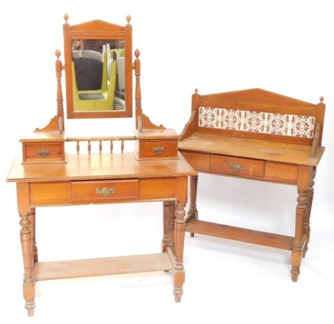 A Victorian pine washstand, with a floral brown tiled splash back, over a single frieze drawer, raised on turned legs united by a half under tier, 108cm high, 95cm wide, 44cm deep., together with a dressing table, the swing framed mirror within a two draw