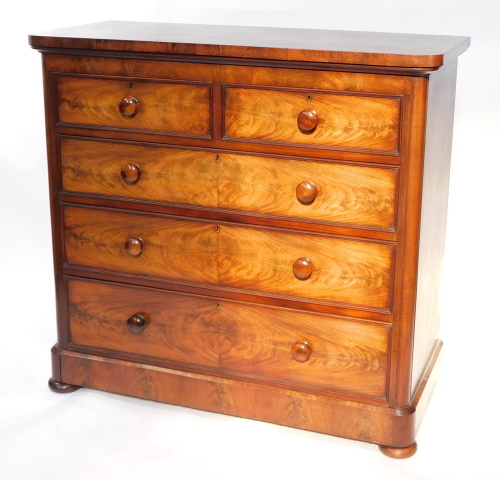 A Victorian flame mahogany chest, of two short over three long drawers, raised on a plinth base above bun feet, 116cm high, 124.5cm wide, 55cm deep.