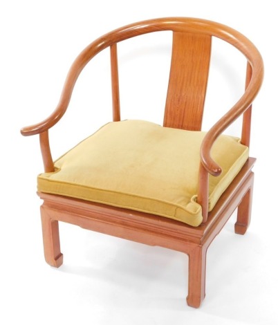 A Chinese teak horseshoe armchair, with a blue cushion seat.