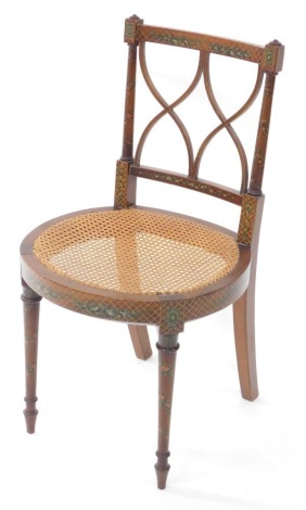 An Edwardian Sheraton style mahogany and painted bedroom chair, decorated with bands of flowers, with cane circular seat, raised on turned legs.