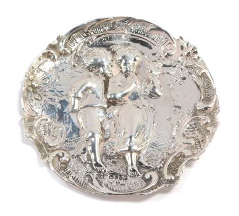 A novelty dish, with hammered detailing of two children holding a dove, with floral border, maker's stamp BD, Birmingham C1900, hallmarks rubbed, 9cm wide, 0.9toz.