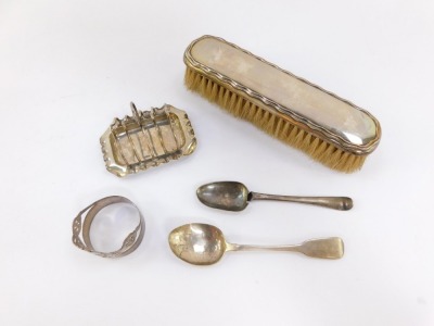 A Victorian silver miniature four division toast rack, Birmingham 1898, Victorian napkin ring of coronet form, Sheffield 1968, George IV Irish Britannia standard silver teaspoon, Dublin 1826, 2.6toz, together with a George V silver backed clothes brush, B - 2