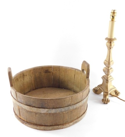 A 19thC coopered oak dairy tub, iron bound, 42cm diameter, together with a gold painted baroque style altar candlestick table lamp, 51cm high. (2)