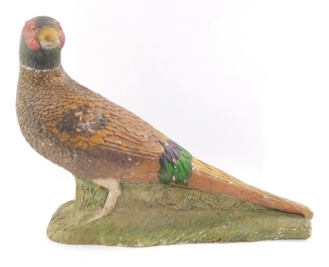 A stone figure of a cock pheasant, modelled on a naturalistic ground, 44cm wide. (AF)