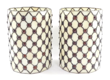 A pair of Tiffany style cylindrical lamp shades, decorated with lattice work and red cabochons, 22.5cm high.