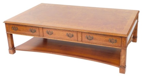 A burr walnut mahogany and herringbone banded coffee table, the rectangular top over three frieze drawers, raised on stile legs, united by a shaped under tier, 46cm high, 152cm wide, 91cm deep.