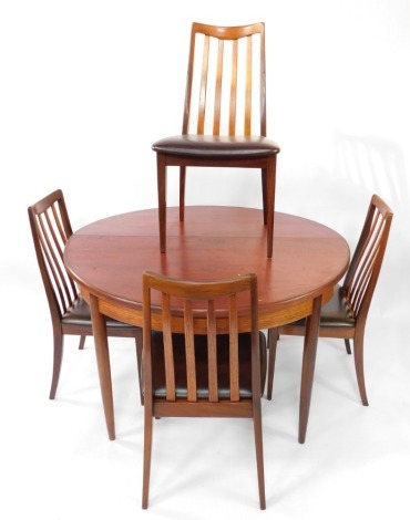 A G-Plan mid century teak extending dining table, raised on turned legs, 74cm high, 122cm wide, 169cm extended, 202cm deep, together with four single dining chairs, with leatherette seats, (5)