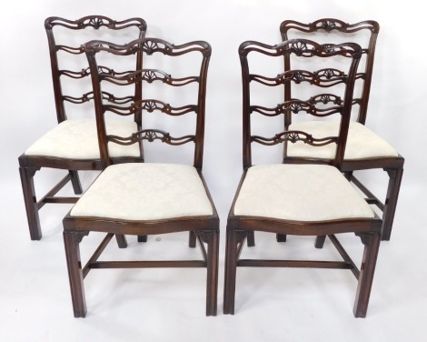 A set of four Chippendale style early 20thC mahogany ladder back single dining chairs, with drop-in seats, raised on channeled square legs, united by an H frame stretcher.