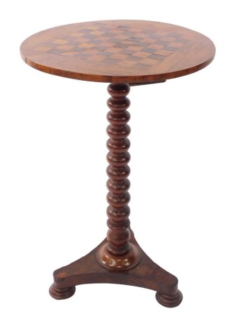 A Victorian specimen wood games table, the circular top inlaid with a rosewood and satin wood chess board, above a bobbin turned mahogany column, over a triform base, on pad feet, 76.5cm high, 48cm diameter.