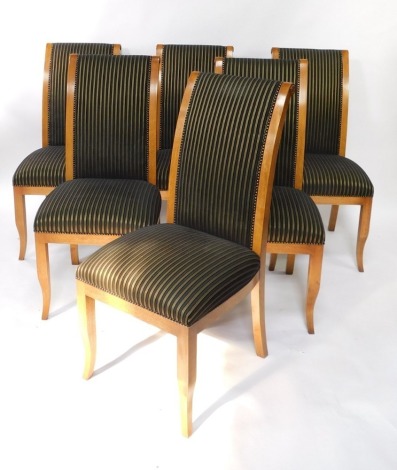 A set of six Reprodux pale oak Regency style dining chairs, with black and gilt striped over stuffed backs and seats.