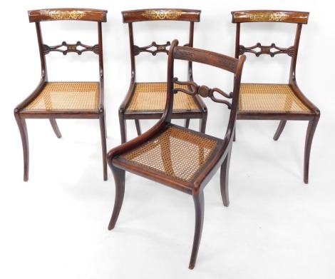 A set of three Regency rosewood and brass inlaid single dining chairs, with cane seats, together with another similar, raised on sabre legs. (4)