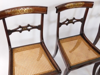 A set of three Regency rosewood and brass inlaid single dining chairs, with cane seats, together with another similar, raised on sabre legs. (4) - 2