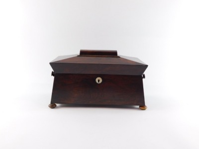 A Regency rosewood tea caddy, of sarcophagus form, the hinged lid opening to reveal a central recess flanked by two canisters, raised on bun feet, 19cm high, 34cm wide, 18cm deep. - 2