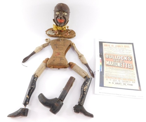 A Victorian marionette of a black gentleman, carved in wood, the torso marked in ink "K Barnard, Bullock's Royal Marrionettes May 4 1874 GM Bridges 1894", together with details of the Bullock's Royal Marionettes.