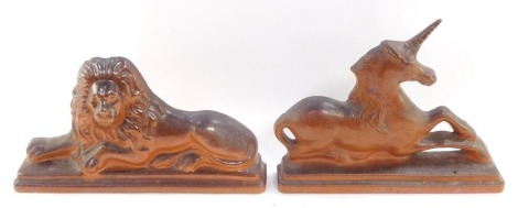 A pair of 19thC salt glazed flat back figures, of a lion and unicorn, each modelled recumbent on a stepped rectangular base, 44cm wide. (AF)