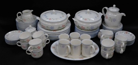 A Royal Doulton Expressions porcelain dinner and tea service, decorated in the Summer Carnival pattern, comprising meat platter, pair of vegetable tureens and covers, salt and pepper, twelve dinner, dessert and side plates, twelve fruit bowls, teapot, cre