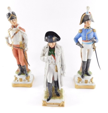 A Capodimonte porcelain figure modelled as Napoleon, 24cm high, and two figures of Napoleonic soldiers, 20cm high. (3)