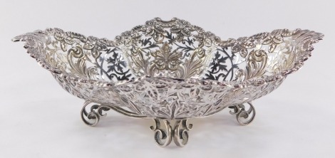 An Edwardian silver basket, of pierced quatre lobe form, embossed with flowers, leaves and rococo scrolls, raised on four double scroll feet, James Dixon and Sons Limited, Sheffield 1904, 10.4toz.