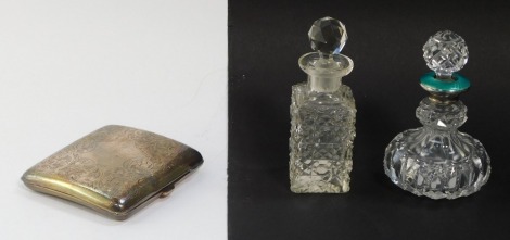 A George V silver cigarette case, of curvilinear form, foliate engraved, shield reserve, Birmingham 1915, 3.7toz, together with a George V cut glass silver and guilloche enamel scent bottle and stopper, London 1927, and a further cut glass scent bottle an