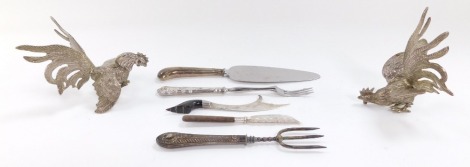 A silver pistol handle cake slice, Sheffield 1959, King's pattern silver handled toasting fork, Sheffield 1979, a silver handled fork, Sheffield 1903, butter knife, Birmingham 1905, and an Arabic knife with a horn handle, together with a pair of silver pl