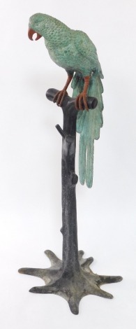 A cast painted metal figure of a parrot, modeled on a perch, 125cm high.