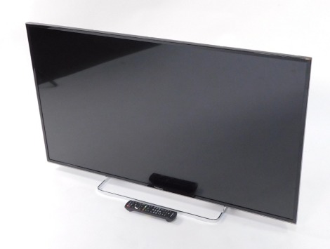 A Panasonic 49" LCD TV, model number TX-49ES503B, with remote.