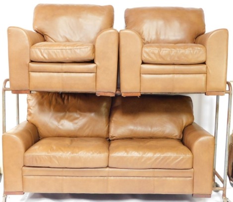 A brown leather three piece suite, comprising three seat sofa with shaped arms and block feet, and two matching armchairs, the sofa 193cm wide. We have instructions from the vendor to sell without reserve.