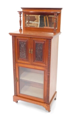 A Victorian mahogany and pine chiffonier, with a galleried top inset rectangular bevelled glass, raised on turned and footed columns, above a pair of carved panelled doors, over a glazed door enclosing a single shelf raised on bracket feet, on casters, 13