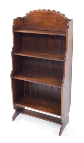 A Victorian oak waterfall bookcase, of four shelves, raised on shaped end supports, 125cm high, 61cm wide, 29cm deep..