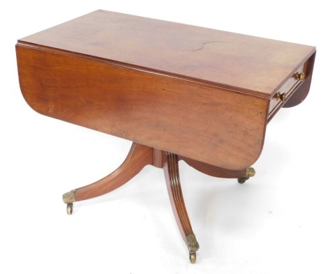 A George III mahogany Pembroke table, raised on a turned column over four channelled out swept legs, brass capped on castors, 73cm high, 102cm wide, 56cm deep, 107cm extended.