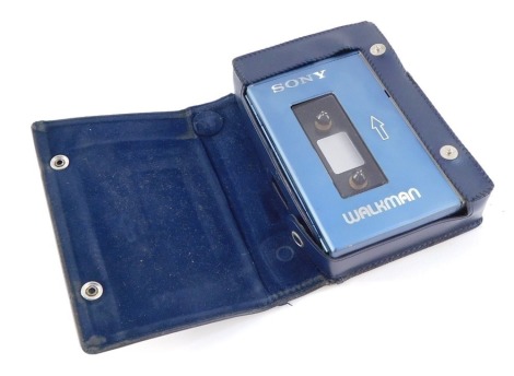 A Sony Walkman, blue leather outer cased.