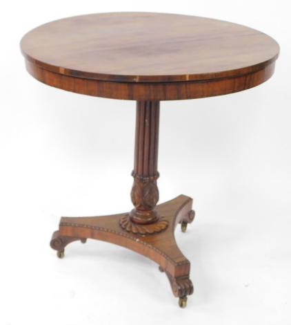 A Regency rosewood occasional table, the circular top over a fluted and lappet carved column above a triform base, on castors, 75.5cm high, 74cm diameter.