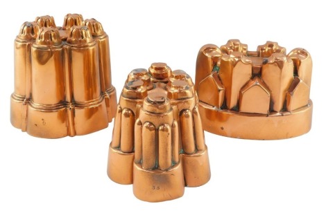 Three Victorian and later copper jelly moulds, of castle form, one bearing a touch mark, the others bearing numbers 35 and 43.