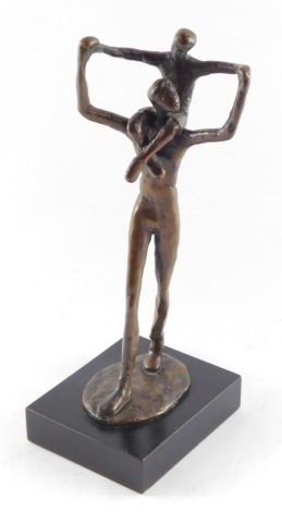 A bronze figure of a father modelled standing with a child on his shoulders, bears signature, raised on a rectangular base, 26cm high.