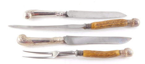 A pair of carving knives, with leaf embossed pistol handles, white metal, together with a George V horn handled carving knife and fork, with silver ferrules and knops, Birmingham 1916. (4)