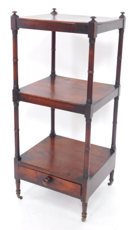 A Victorian mahogany three tier whatnot, raised on turned supports, with a frieze drawer below, on turned feet, brass capped on castors, 113cm high, 148cm wide, 43cm deep.