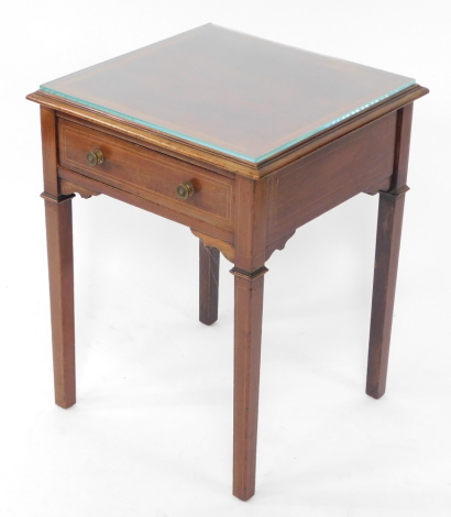 An Edwardian mahogany and satinwood cross banded occasional table, cut down, with a single frieze drawer, raised on tapering square legs, 52cm high, 40cm diameter.