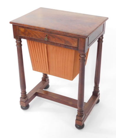 A Victorian mahogany and cross banded sewing table, with a single frieze drawer over a bucket drawer, raised on turned columns united by an H frame stretcher, raised on bun feet, 74.5cm high, 56cm wide, 40cm deep.