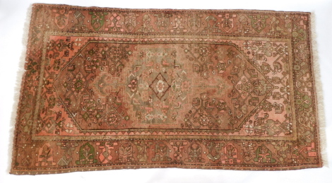 A Caucasian red ground rug, decorated with gulls and flowers within repeating geometric borders, 223cm x 128cm.