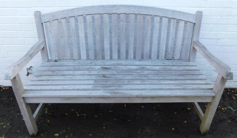 A slatted garden bench with shaped arched back, on block supports joined by vertical stretchers, 150cm wide. N.B. Option on Lot 613 at the same price.